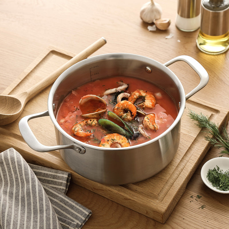 Fischsuppe mit Garnelen in einem Kochtopf aus 3-Ply Edelstahl auf einem Schneidebrett