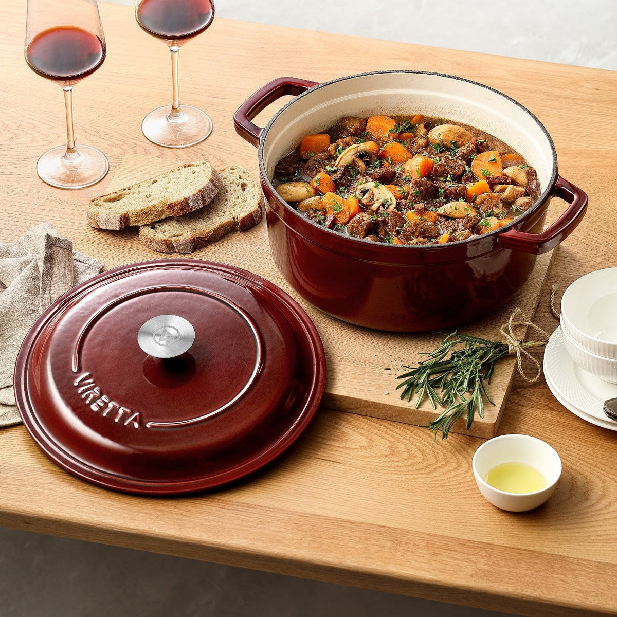 Johannisbeerroter Gusseisentopf mit Bœuf bourguignon, daneben der Deckel